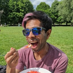 An image of Shoaib eating cake in the park